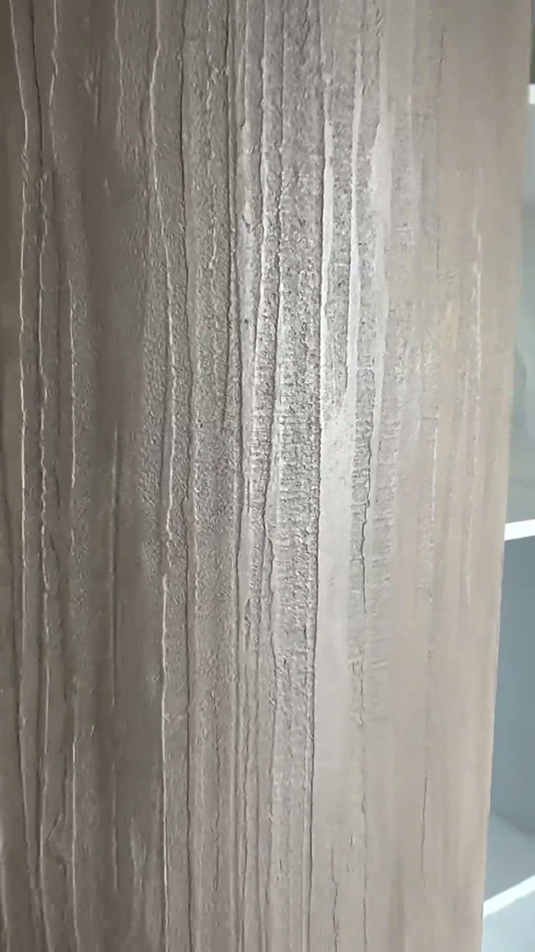 Bamboo texture in a warm cappuccino tone wrapping a curved wall in a new architectural home, its fine vertical movement catching the light against flat white walls